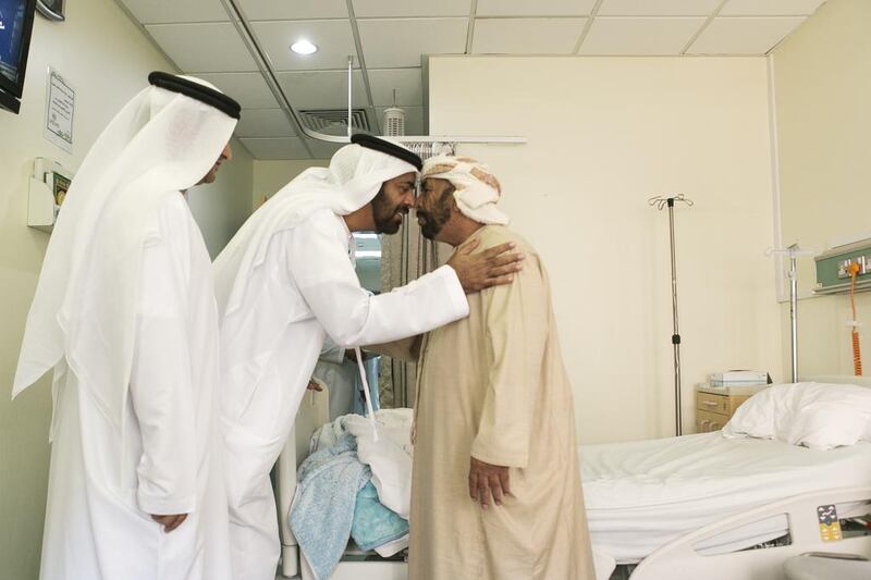 From left, Salim bin Huwaidan and Salem Al Ameri, head of the FNC’s health, labour and social affairs committee, visit a patient during a tour of Al Dhaid Hospital. Reem Mohammed / The National