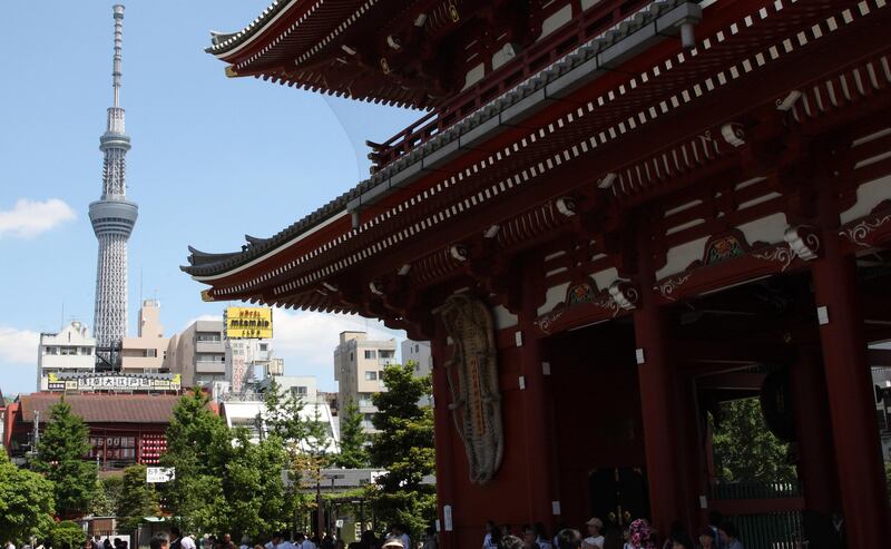The Tokyo Skytree, left, is seen from the Sensoji temple in Tokyo, Japan, on Wednesday, May 23, 2012. The Tokyo Skytree, twice as tall as the Eiffel Tower, and its surrounding retail and office complex opened yesterday to an estimated 200,000 visitors. Photographer: Tomohiro Ohsumi/Bloomberg