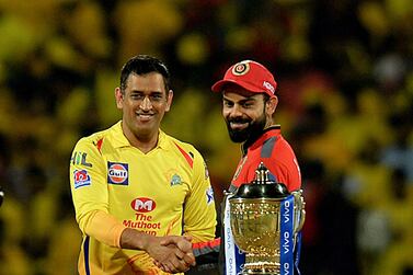 Chennai Super Kings cricket captain Mahendra Singh Dhoni and Royal Challengers Bangalore cricket captain Virat Kohli (R) gesture beside IPL trophy ahead of the Indian Premier League (IPL) Twenty20 cricket match between Chennai Super Kings and Royal Challengers Bangalore at the M. A. Chidhambaram Stadium in Chennai on March 23, 2019. (Photo by ARUN SANKAR / AFP) / ----IMAGE RESTRICTED TO EDITORIAL USE - STRICTLY NO COMMERCIAL USE----- / GETTYOUT