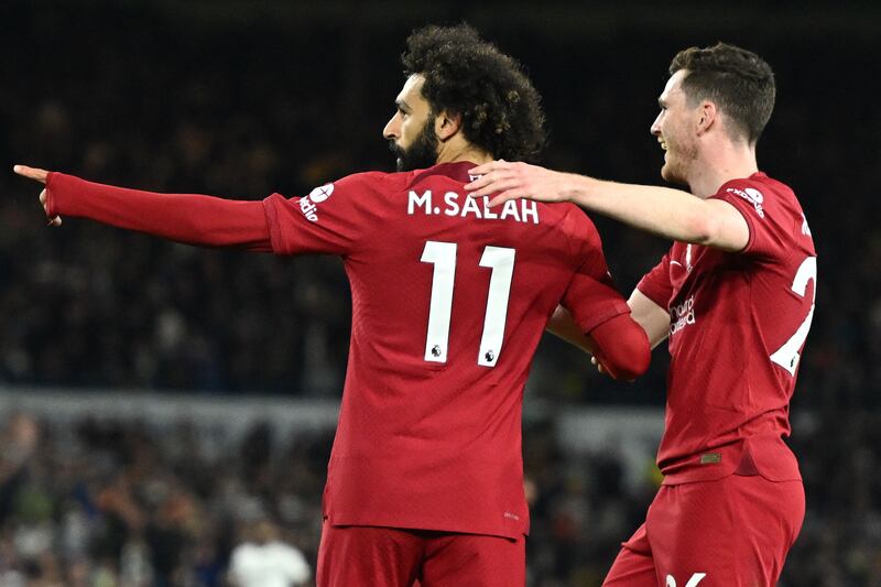 Liverpool striker Mohamed Salah celebrates with Andrew Robertson after scoring their second goal. AFP