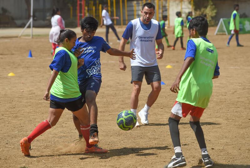 Former Spain international midfielder Xavi looks on as he plays with Indian children a football game in Mumbai on March 18, 2019. Xavi is the first global ambassador for the Generation Amazing programme. All pictures by AFP