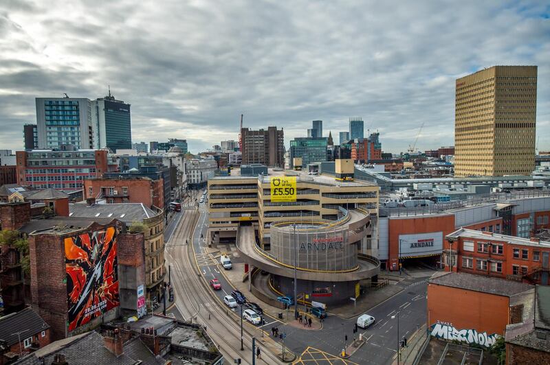 Traffic passes the Arndale Centre shopping mall in Manchester. Bloomberg