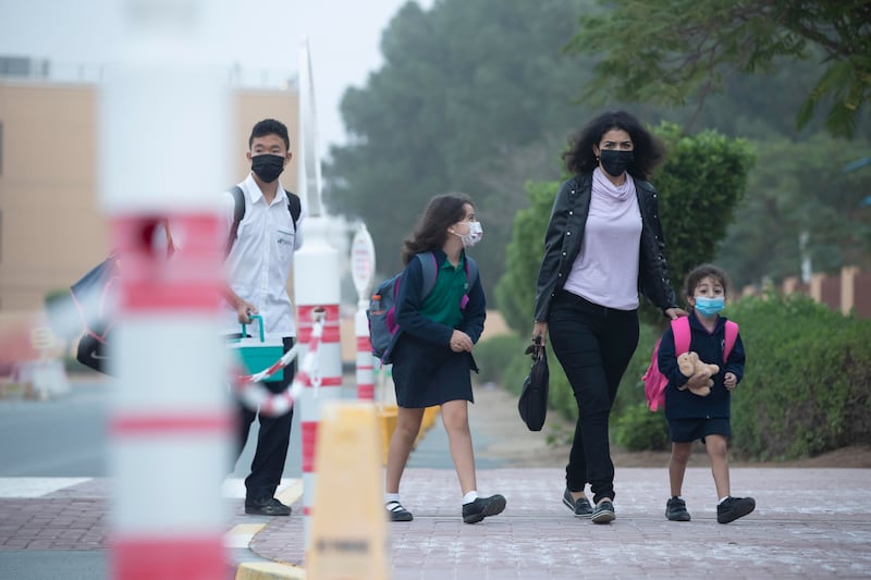 Parents, pupils and staff arrive at the Greenfield International School in Dubai Investments Park for the start of a new term after the winter break. Antonie Robertson / The National