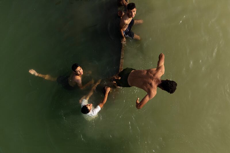 Young men swim in the Shatt Al Arab waterway, formed at the confluence of the Euphrates and Tigris rivers, in Iraq's southern city of Basra in May. AFP