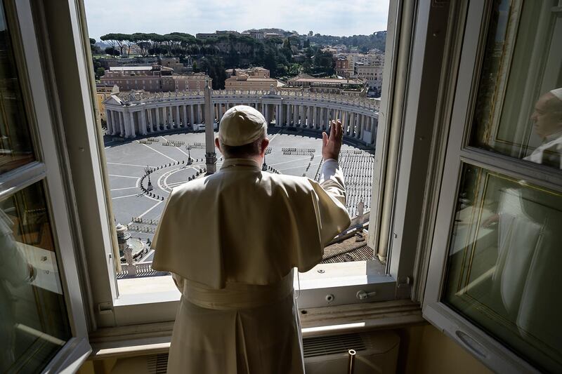 Pope Francis delivers a blessing over an empty St. Peter's square at the Vatican, after his streamed Angelus prayer. The Vatican said on March 15 that its traditional Easter week celebrations would be held without worshippers due to the coronavirus. AFP