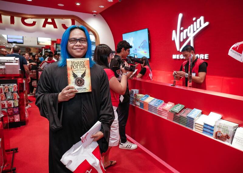 Robert Maramag picks up a copy of Harry Potter and the Cursed Child at Virgin Megastore at the Mall of the Emirates. Victor Besa for The National