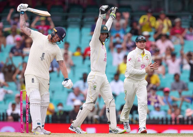 England’s Ben Stokes (L) reacts as Australia's Steve Smith (R) celebrates taking a catch to dismiss him on day five of the fourth Ashes cricket Test between Australia and England at the Sydney Cricket Ground (SCG) on January 9, 2022.  (Photo by DAVID GRAY  /  AFP)  /  -- IMAGE RESTRICTED TO EDITORIAL USE - STRICTLY NO COMMERCIAL USE --