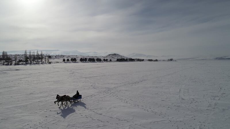 A man travels on a horse-drawn carriage over the frozen lake Cildir, Turkey. Reuters