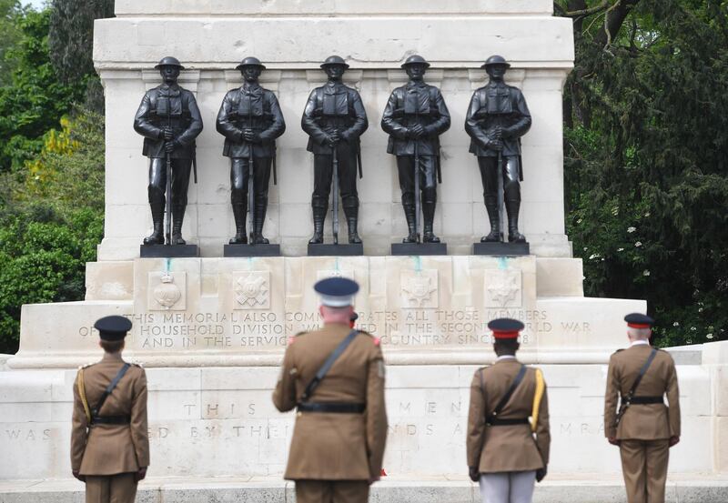 Officers from the Household division observe a two-minute silence to commemorate the Victory Day 75th anniversary at the Guards memorial at the Horse Guards Parade in London. EPA