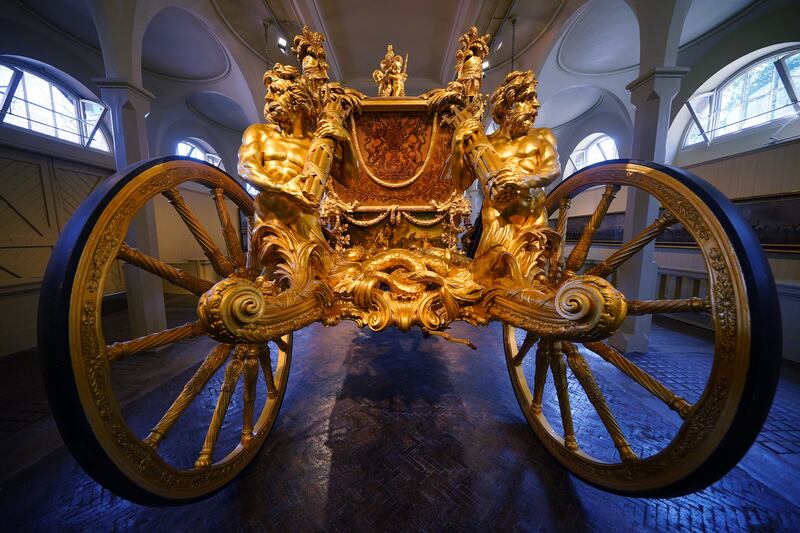 The Gold State Coach on display at the Royal Mews in Buckingham Palace. PA