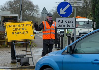 Volunteer marshal and Cranleigh resident Adrian Clarke directing traffic on the first day of the village's vaccination effort. Martin Bamford for The National
