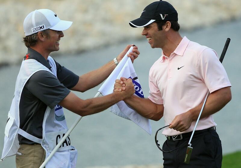BAHRAIN, BAHRAIN - JANUARY 30:  Paul Casey of England celebrates with his caddie Christian Donald on the 18th green after winning the Volvo Golf Champions at The Royal Golf Club on January 30, 2011 in Bahrain, Bahrain.  (Photo by Andrew Redington/Getty Images) *** Local Caption ***  GYI0063256524.jpg
