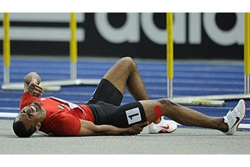 Ali Obaid Al Shirook lies on the floor after suffering a thigh injury during his 400m hurdles heat.