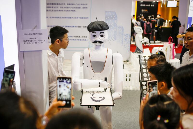 A robot draws a portrait at the World Robot Conference in Beijing. EPA