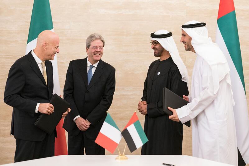 ABU DHABI, UNITED ARAB EMIRATES -  March 11, 2018: HH Sheikh Mohamed bin Zayed Al Nahyan, Crown Prince of Abu Dhabi and Deputy Supreme Commander of the UAE Armed Forces (3rd L), and HE Paolo Gentiloni Silveri, Prime Minister of Italy (2nd L), speak with Claudio Descalzi CEO of Eni (L), and HE Khaldoon Khalifa Al Mubarak, CEO and Managing Director Mubadala, Chairman of the Abu Dhabi Executive Affairs Authority and Abu Dhabi Executive Council Member (R), after witnessing the signing of a memorandum of understanding (MOU), between Mubadala and Eni, at Al Shati Palace.   
( Ryan Carter for the Crown Prince Court - Abu Dhabi )
---