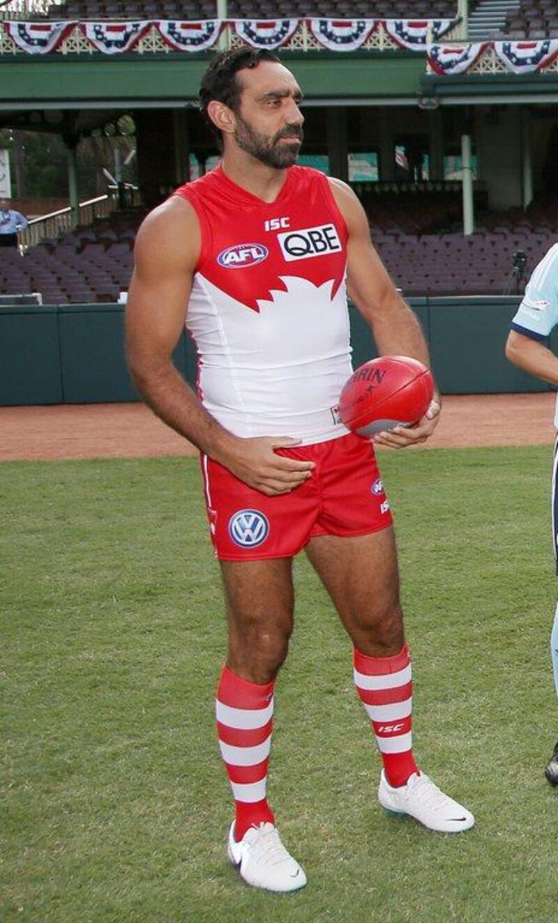 Sydney Swans player Adam Goodes holds an Australian Rules Football at the Sydney Cricket Ground. The continued booing of Goodes him when he plays for the Swans in the AFL had led to the point where he was thought to be considering retirement. Rick Rycroft / AP / March 19, 2014 