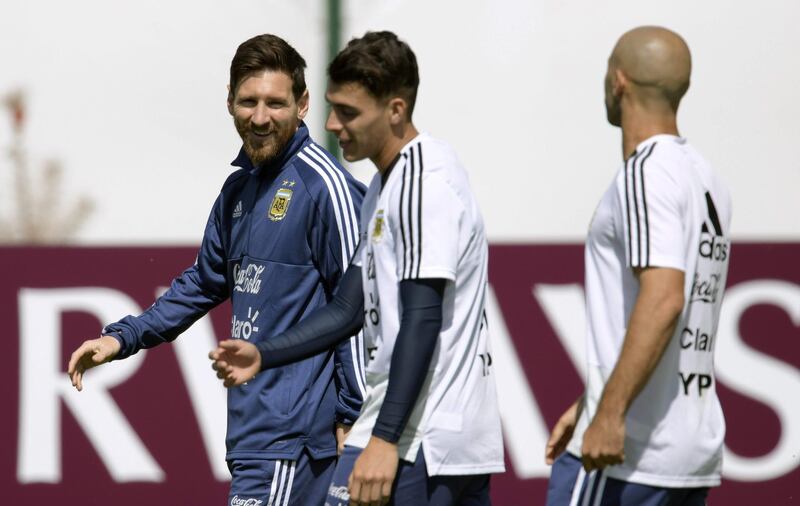 Argentina's forward Lionel Messi, left, walks past Cristian Pavon during training session. Juan Mabromata / AFP