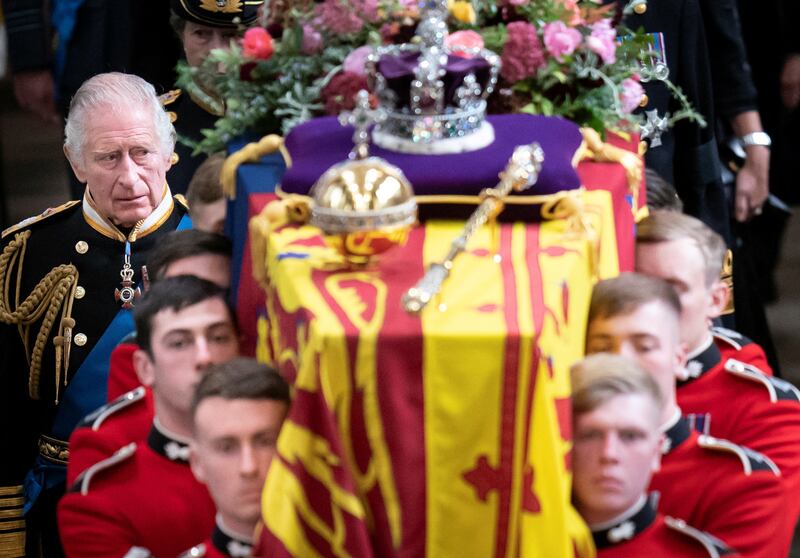 King Charles III follows behind the coffin of Queen Elizabeth II, draped in the Royal Standard with the Imperial State Crown and the Sovereign's orb and sceptre on top, as it is carried out of Westminster Abbey after her state funeral. Reuters