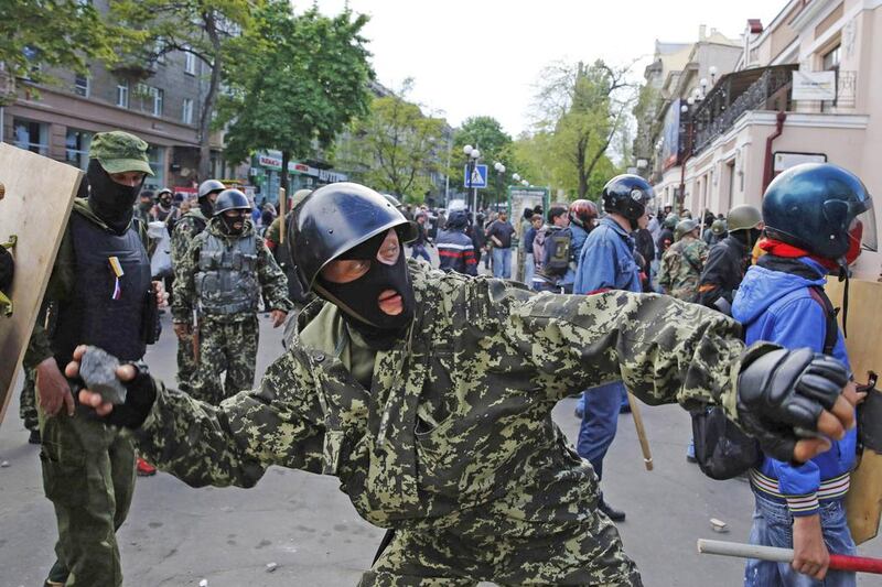 A pro-Russian activist hurls a rock at supporters of Ukraine’s government during clashes in the streets of Odessa on May 2, 2014. Yevgeny Volokin / Reuters