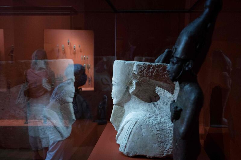 People look at art pieces displayed during the exhibition "Pharaon, Osiris and mummy"  at the museum Granet in Aix-en-Provence, southeastern France. AFP