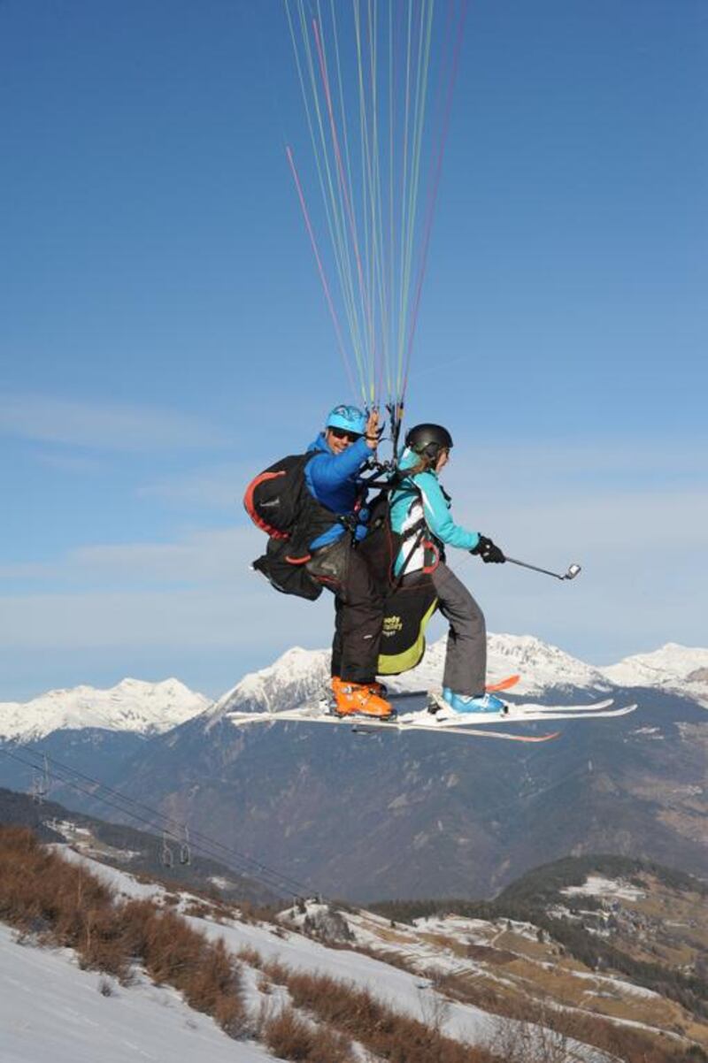 Mary Novakovich and her guide Franck from the company Here We Go Parapente paragliding above Valmorel. Adam Batterbee