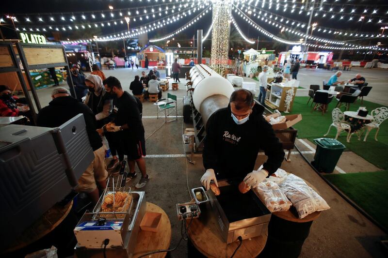 A vendor prepares hamburgers at Radical Barbecue, a food stand, at Al Aali Mall amid the coronavirus disease (COVID-19) pandemic, in Manama, Bahrain February 27, 2021. Picture taken February 27, 2021. REUTERS/Hamad I Mohammed