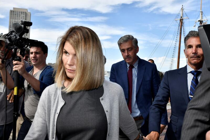 FILE PHOTO: Actress Lori Loughlin, and her husband, fashion designer Mossimo Giannulli leave the federal courthouse after a hearing on charges in a nationwide college admissions cheating scheme in Boston, Massachusetts, U.S., August 27, 2019.  REUTERS/Josh Reynolds/File Photo