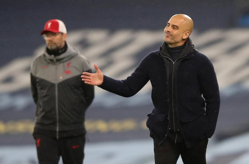 Manchester City manager Pep Guardiola with his Liverpool counterpart Jurgen Klopp in the background. Reuters