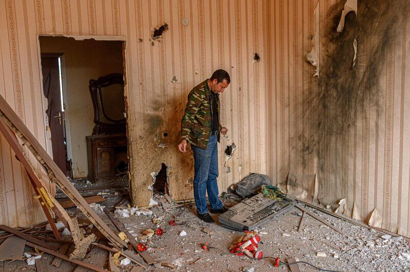 TOPSHOT - Movsumov Qowkar, 32, accesses the damage to his home which he came to check during fighting over the breakaway region of Nagorno-Karabakh, in the city of Terter early on October 18, 2020.  The origins of a flareup in fighting over Nagorno-Karabakh that has now killed hundreds and threatens to involve regional powers Turkey and Russia are hotly contested and difficult to independently verify. Both sides accuse the other of striking first on September 27 over the ethnic Armenian region of Azerbaijan. / AFP / BULENT KILIC
