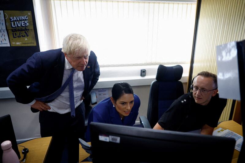 Mr Johnson and Ms Patel are shown the Critical Incident Desk during their visit with members of Thames Valley Police. AFP