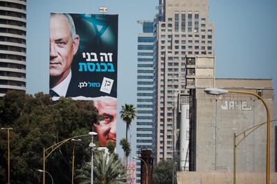 A Blue and White party election campaign banner depicting its leader, Israeli Defence Minister Benny Gantz, alongside Israeli Prime Minister Benjamin Netanyahu is seen, ahead of the March 23 ballot, in Tel Aviv, Israel March 17, 2021. REUTERS/Amir Cohen