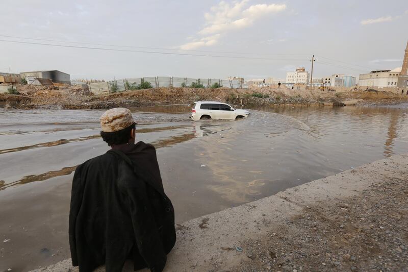 A man looks on as a vehicle drives through a flooded road following heavy rains in Sana'a, Yemen . Heavy rains affected most parts of Yemen.  EPA