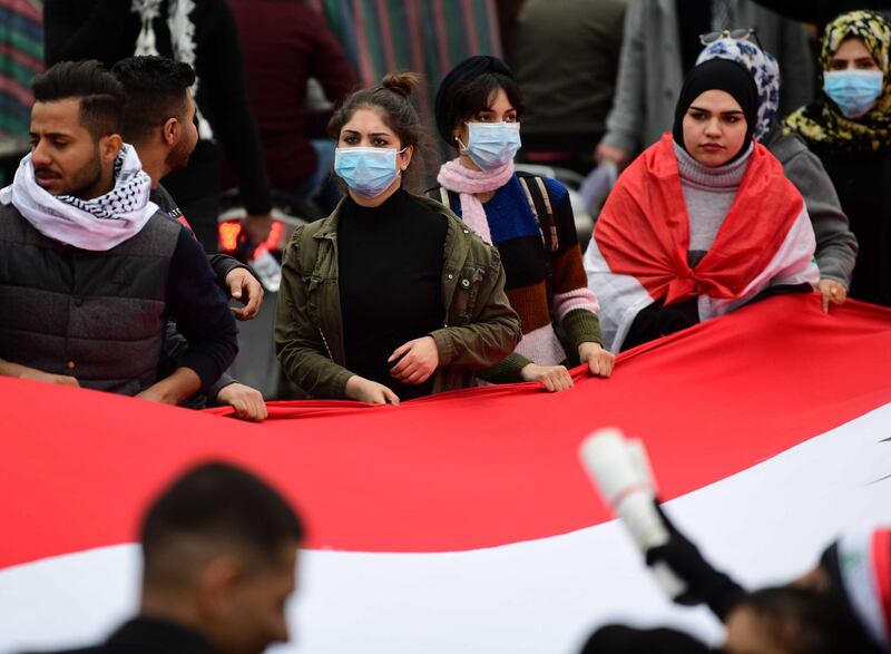 Iraqi university students carry the Iraqi national flag during a strike and protests in central Baghdad.  EPA