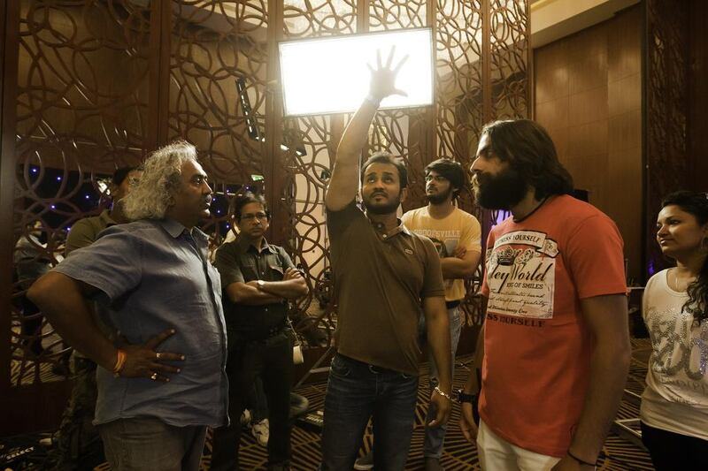 Director Mustafa Raj, centre, talks with his crew during the shooting of the movie Switchh, in Dubai. Jaime Puebla / The National 