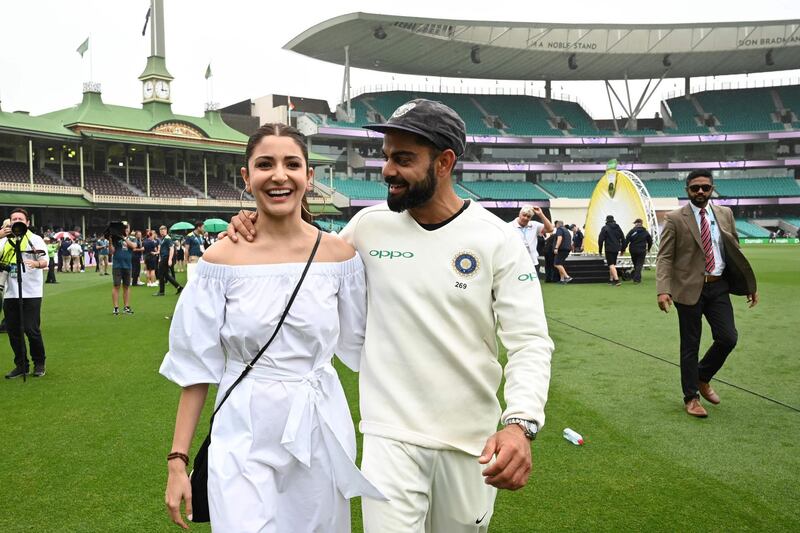 (FILES) In this file photo taken on January 07, 2019 India's captain Virat Kolhi and his wife Anushka Sharma walk on the field as they celebrate India's series win on the fifth day of the fourth and final cricket Test against Australia at the Sydney Cricket Ground in Sydney. The 32-year-old and his Bollywood actress wife Anushka Sharma are expecting a baby in January and Kohli has been given permission by the Indian cricket board to return home after the first Test in Adelaide, which begins on December 17, 2020. - -- IMAGE RESTRICTED TO EDITORIAL USE - STRICTLY NO COMMERCIAL USE --
 / AFP / Peter PARKS / -- IMAGE RESTRICTED TO EDITORIAL USE - STRICTLY NO COMMERCIAL USE --
