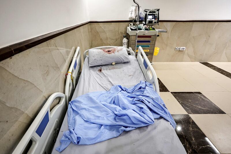 A bullet hole on a pillow covered in blood on a hospital bed at Ibn Sina Hospital. AFP