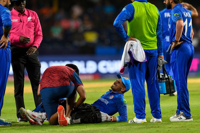Afghanistan wicketkeeper Rahmanullah Gurbaz receives injury treatment. AFP