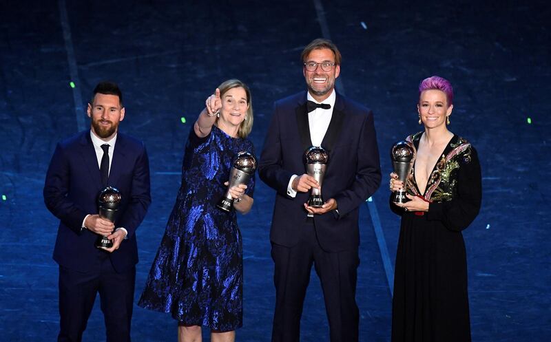 Lionel Messi poses after winning the Best FIFA Men's player award with the winner of the Best FIFA Men's coach award Liverpool manager Jurgen Klopp, winner of the Best FIFA Women's player award USA women's Megan Rapinoe and the winner of the Best FIFA Women's coach award USA women's coach Jill Ellis. Reuters