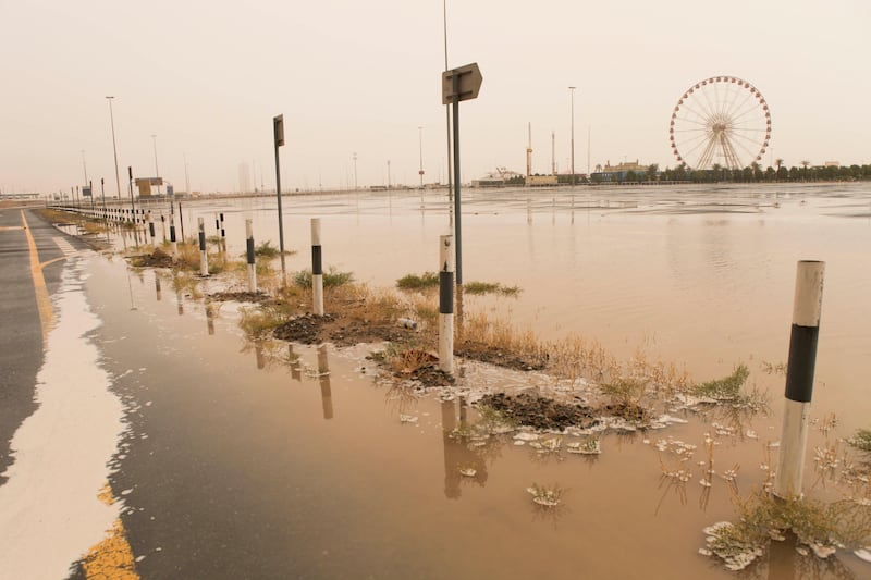 Dubai, United Arab Emirates - April 7 2013 - Heavy rains and a sandstorm has resulted in flooding of the parking lot of Global Village off Emirates Road.  tags: WEATHER (Razan Alzayani / The National)