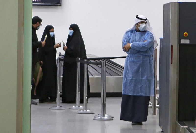 Kuwaitis coming back from Iran wait at Sheikh Saad Airport in Kuwait City before being taken to a hospital to be tested for coronavirus.  AFP