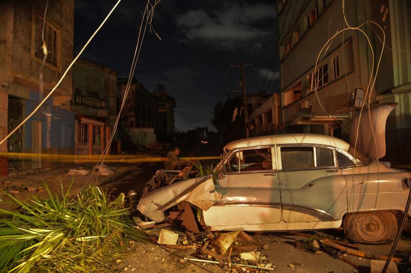 A damaged car is seen in the tornado-hit Luyano neighbourhood in Havana early on January 28, 2019.&nbsp; AFP

