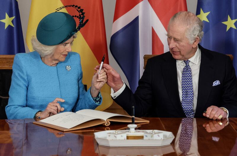 King Charles and Queen Consort Camilla sign the guest book at the presidential Bellevue Palace in Berlin. AFP