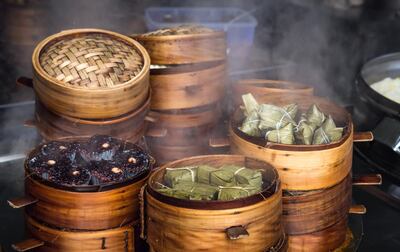 Traditional Chinese steamed food in bamboo steamers in a Market . .