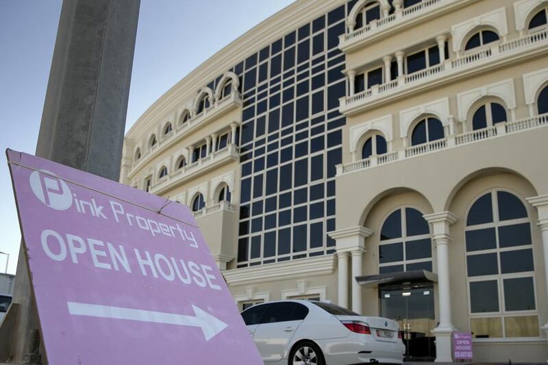 An open house sign at a new apartment building near Al Bateen airport in Abu Dhabi. Silvia Razgova / The National