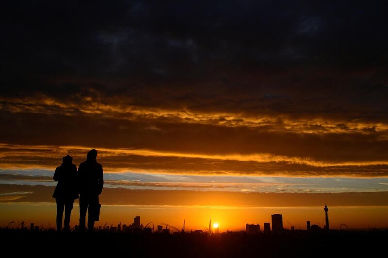 People view the sunrise over London as the second lockdown in England ends. Reuters