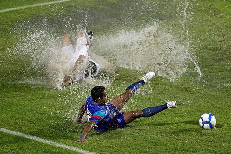 An unidentifiable UAE player slides through the monsoon. Any guesses?

Gurinder Osan / AP Photo