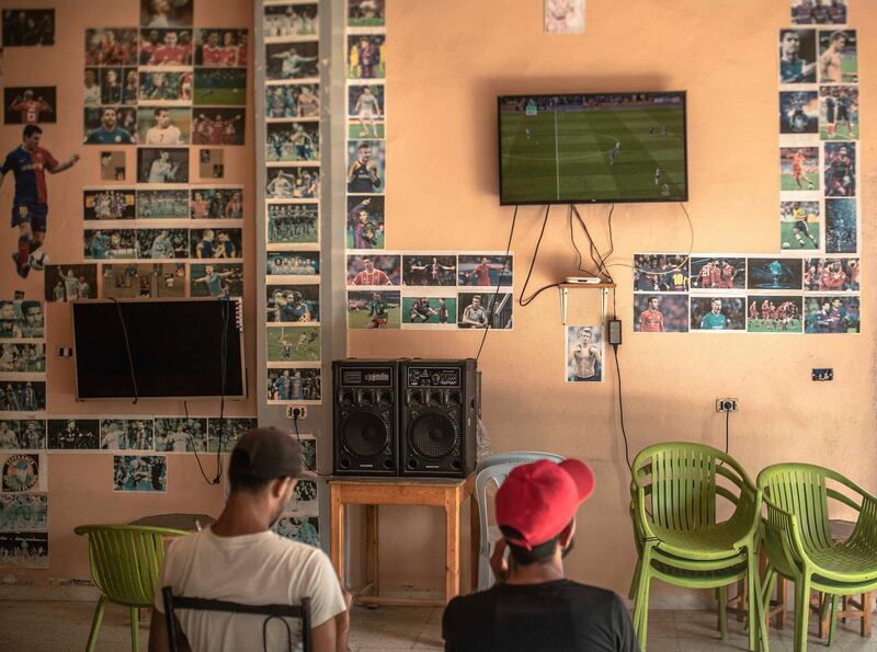 People watch a soccer game between Tottenham Hotspur and Leicester City in the Premier League, in a coffee shop in Nabeul, Tunisia. AP Photo