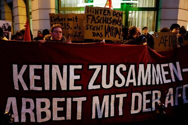 A protestor holds up a banner which reads "No cooperation with the AFD" during a rally outside the heahquaters of the Free Democratic Party (FDP) in Berlin on February 5, 2020. The tiny central state of Thuringia broke a German political taboo when a candidate for the regional premiership was unexpectedly heaved into office with the help from the far-right AfD party. Thomas Kemmerich, a politician from the economically liberal Free Democratic Party (FDP), scored 45 votes, leapfrogging incumbent Bodo Ramelow of the Left party by one vote. / AFP / John MACDOUGALL