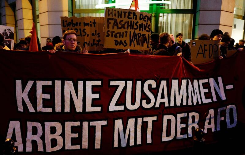 A protestor holds up a banner which reads "No cooperation with the AFD" during a rally outside the heahquaters of the Free Democratic Party (FDP) in Berlin on February 5, 2020. The tiny central state of Thuringia broke a German political taboo when a candidate for the regional premiership was unexpectedly heaved into office with  the help from the far-right AfD party. Thomas Kemmerich, a politician from the economically liberal Free Democratic Party (FDP), scored 45 votes, leapfrogging incumbent Bodo Ramelow of the Left party by one vote.

  / AFP / John MACDOUGALL
