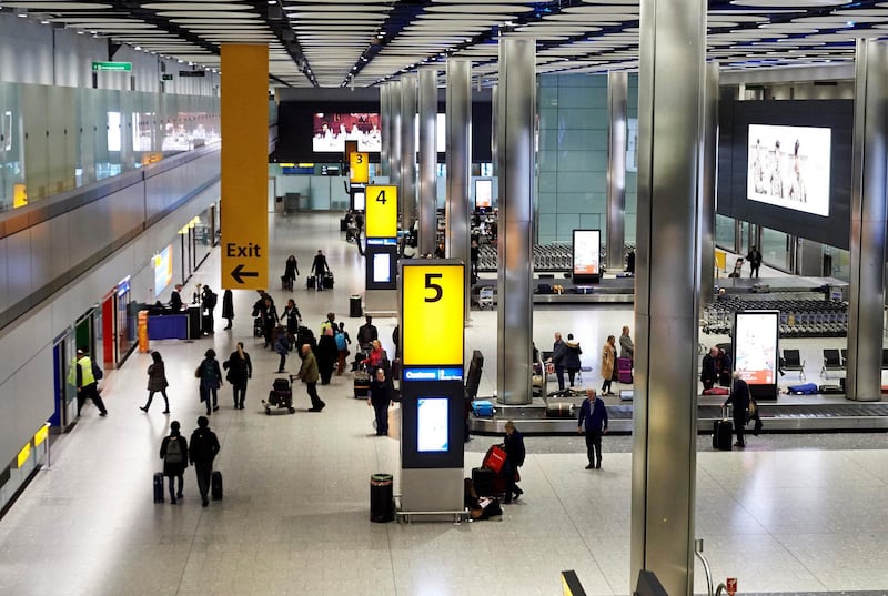 LONDON, ENGLAND - DECEMBER 19: Passengers collect their luggage from the baggage reclaim area of Terminal 5 at London Heathrow Airport on December 19, 2018 in London, England. The Government has published an immigration white paper detailing proposals for changes to the current immigration laws and levels post Brexit. (Photo by Niklas Halle'n - WPA Pool/Getty Images)